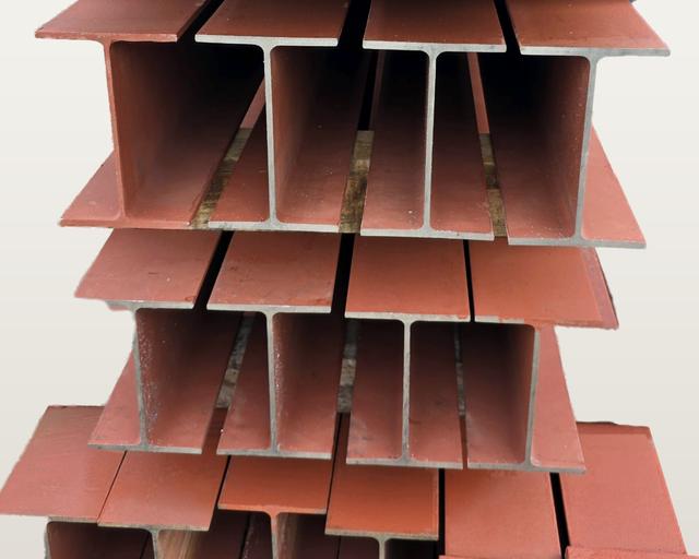 Painted steel universal beams seen end-on, showing the I-shaped cross-section